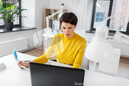 Image of businesswoman woman with laptop computer at office