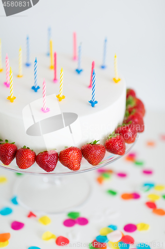 Image of close up of birthday cake with candles on stand