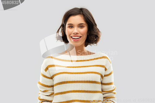 Image of happy smiling woman in striped pullover