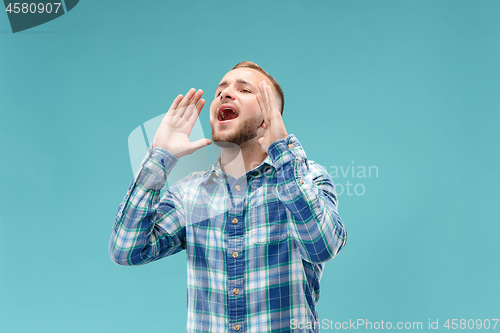 Image of Isolated on pink young casual man shouting at studio