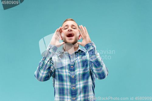 Image of Isolated on pink young casual man shouting at studio