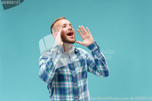 Image of Isolated on pink young casual man shouting at studio