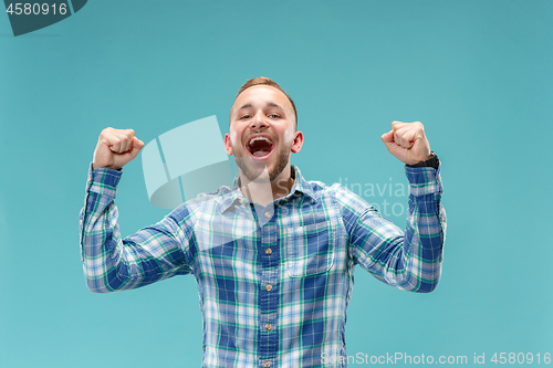 Image of Winning success man happy ecstatic celebrating being a winner. Dynamic energetic image of male model