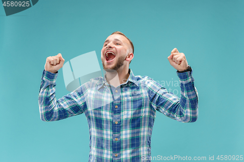 Image of Winning success man happy ecstatic celebrating being a winner. Dynamic energetic image of male model