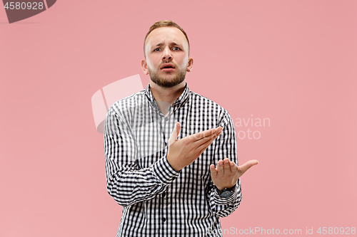 Image of Beautiful male half-length portrait isolated on pink studio backgroud.