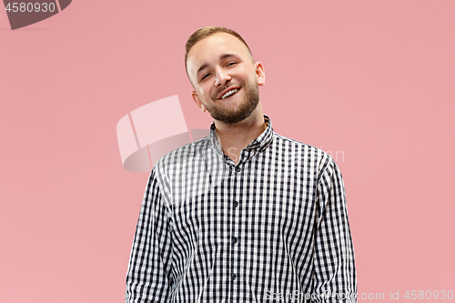 Image of The happy business man standing and smiling against pink background.