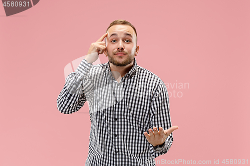 Image of Beautiful male half-length portrait isolated on pink studio backgroud.