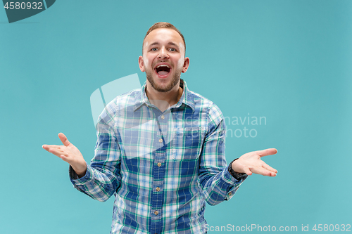 Image of Beautiful male half-length portrait isolated on blue studio backgroud.