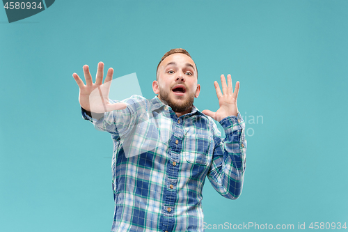 Image of Portrait of the scared man on blue