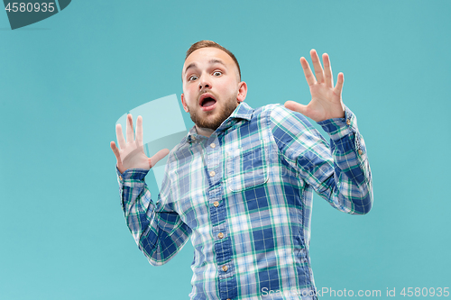 Image of Portrait of the scared man on blue