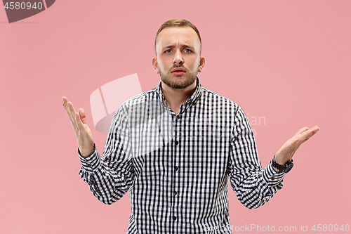 Image of Beautiful male half-length portrait isolated on pink studio backgroud.