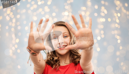 Image of happy teenage girl in red t-shirt giving high five