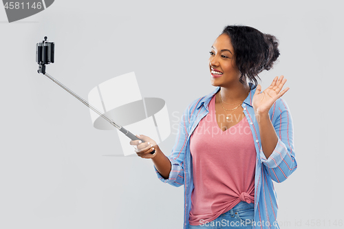 Image of african american woman taking selfie by smartphone