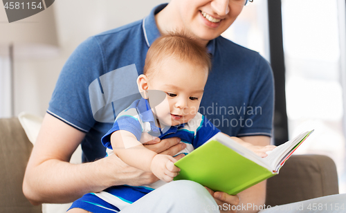 Image of happy father and little baby son with book at home