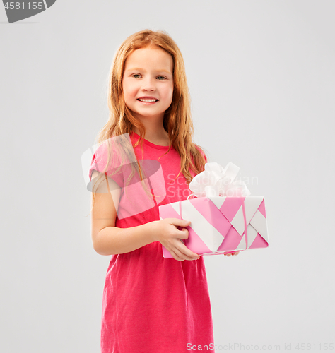 Image of smiling red haired girl with birthday gift
