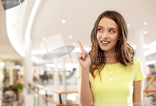 Image of teenage girl pointing finger up in shopping mall