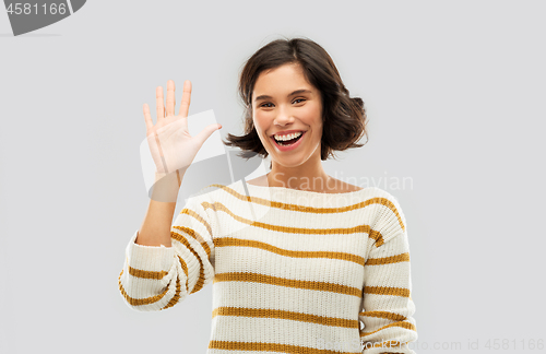 Image of happy smiling woman showing five fingers