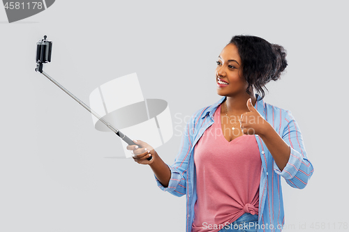 Image of african american woman taking selfie by smartphone