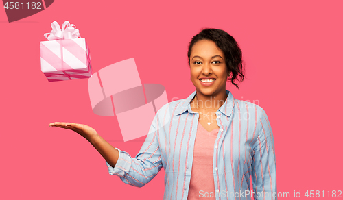 Image of happy african american woman with birthday present