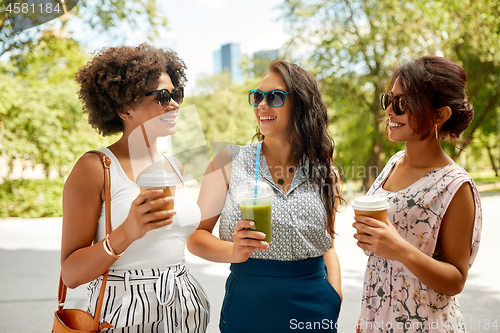 Image of happy women or friends with drinks at summer park