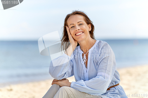 Image of happy smiling woman on summer beach