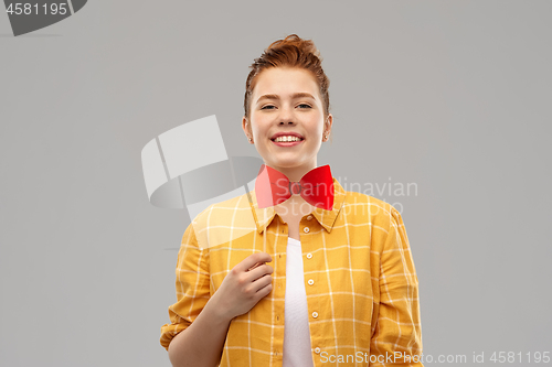 Image of smiling red haired teenage girl with big bowtie