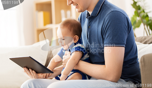 Image of happy father and baby son with tablet pc at home