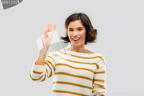 Image of happy smiling woman showing four fingers