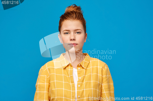 Image of red haired teenage girl in checkered shirt