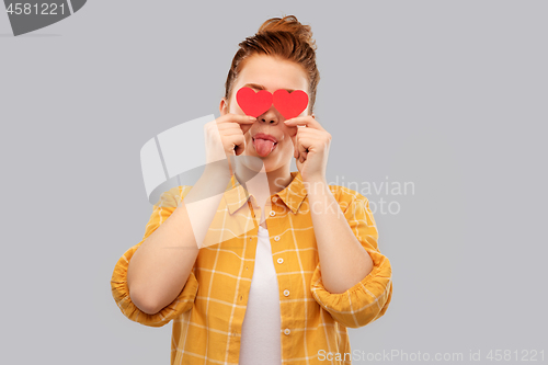 Image of smiling red haired teenage girl with hearts