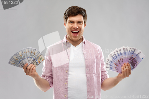 Image of happy young man with fans of euro and dollar money