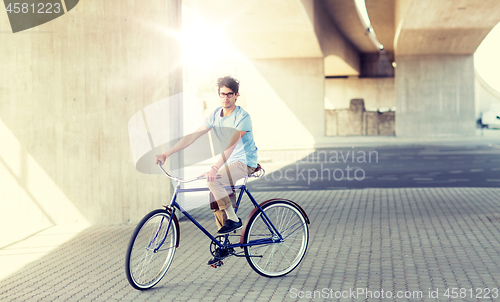 Image of young hipster man riding fixed gear bike