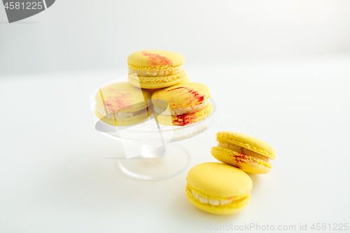 Image of lemon yellow macarons on glass confectionery stand