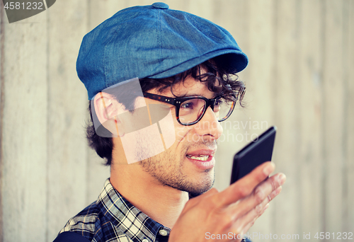 Image of man recording voice or calling on smartphone