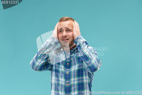 Image of Handsome man in stress isolated on blue