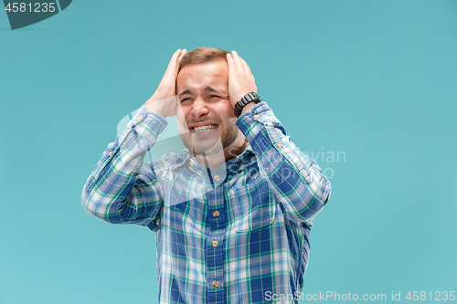 Image of Handsome man in stress isolated on blue