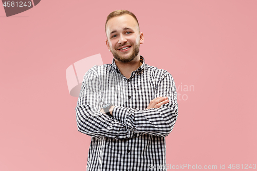 Image of The happy business man standing and smiling against pink background.