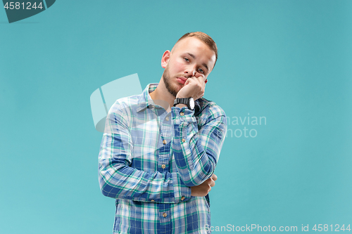 Image of Beautiful bored man bored isolated on blue background