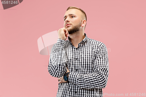 Image of Young serious thoughtful businessman. Doubt concept.