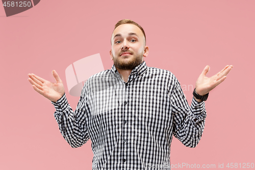 Image of Beautiful male half-length portrait isolated on pink studio backgroud.