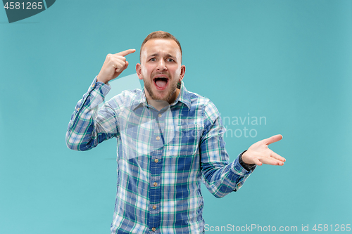 Image of Beautiful male half-length portrait isolated on blue studio backgroud.