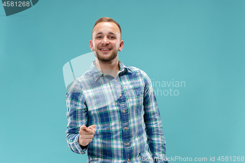 Image of The happy business man point you and want you, half length closeup portrait on blue background.