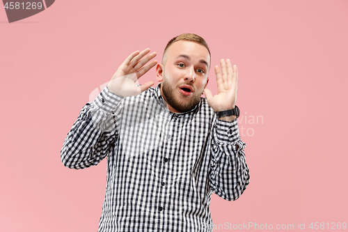 Image of Portrait of the scared man on pink