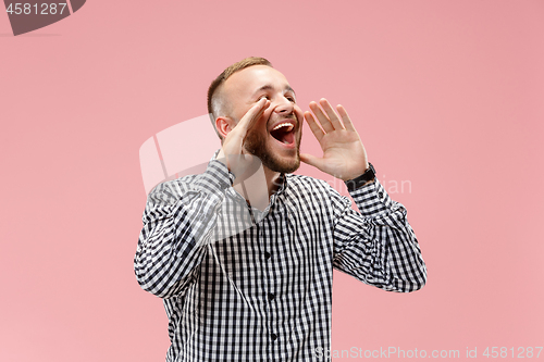 Image of Isolated on pink young casual man shouting at studio