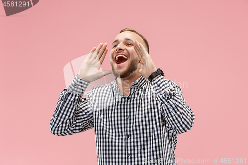 Image of Isolated on pink young casual man shouting at studio