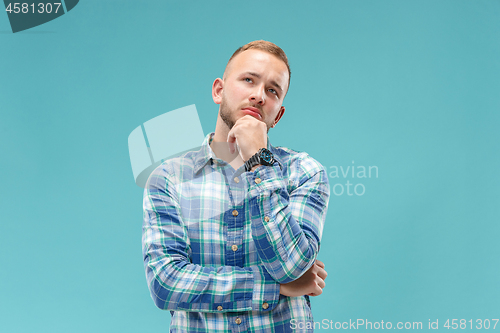 Image of Young serious thoughtful businessman. Doubt concept.