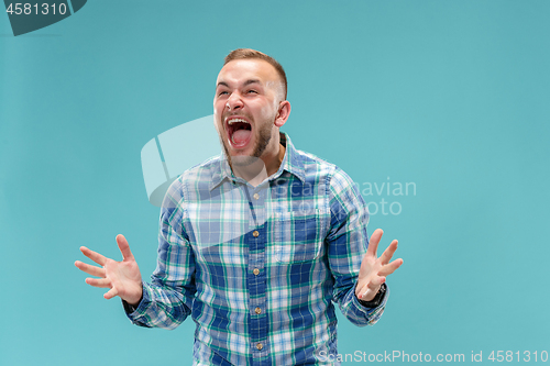 Image of The young emotional angry man screaming on studio background