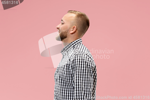 Image of The happy business man standing and smiling against pink background.