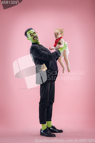 Image of Halloween Family. Happy Father and Children Girl in Halloween Costume and Makeup