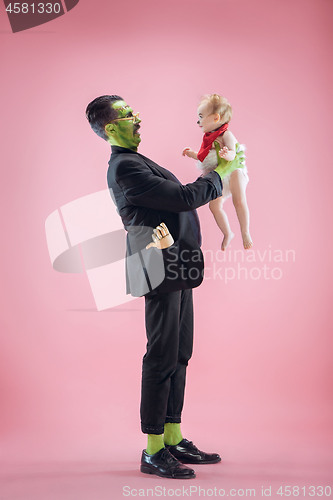 Image of Halloween Family. Happy Father and Children Girl in Halloween Costume and Makeup